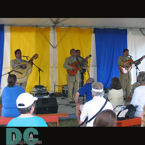 A trio of musicians playing and singing a "serenada" for the audience.