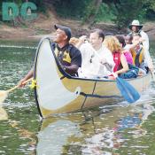 Ferry boat captain Ishan transports eight fresh partygoars accross a calm part of the Potomac River. 