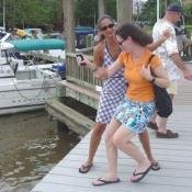 Oh no, she's going to push her sister in the water.