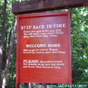 Sign - STEP BACK IN TIME - Follow this path to the year 1771. You will meet a poor tenant family going about their daily chores.