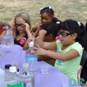 These girls have fun learning how to mix ingredients.