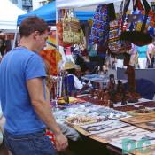 This young man views african craftwork 
