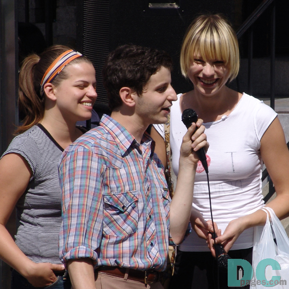 Two young ladies enjoy this talented friend's voice.