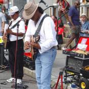 Despite not performing on a stage, these two musicians has a big crowd listening to their performance.