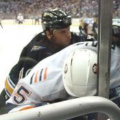 Brendan Witt begins the 2003 season by slamming Islanders Jason Blake into the boards.