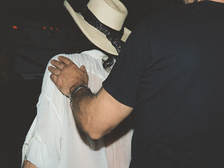 Steven Tyler's bodyguard rushes him to his limo.