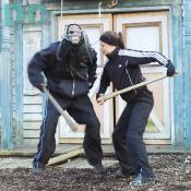 Out of nowhere a ghoul jumps out of a door to attack me. But, he stopped by this brave women.