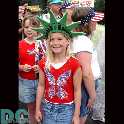 A young girl takes a moment to let our cameras take a picture of her interesting headgear.