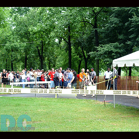 The long line at this security checkpoint went down the street.  All people who were trying to get seats on the lawn needed to be checked.