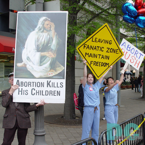 Side-By-Side: Pro-Life and Pro-Choice. A Pro-life demonstrator holds a 