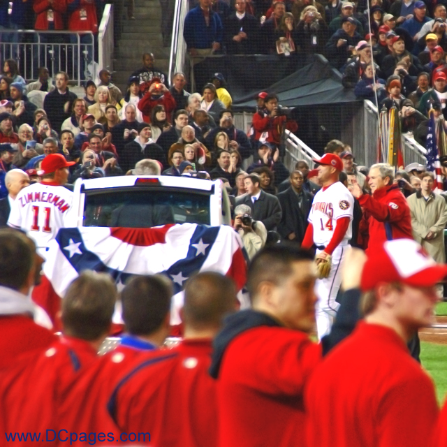 One last wave to the crowd from President Bush as he and manager Manny Acta walk of the field at Nationals Park.