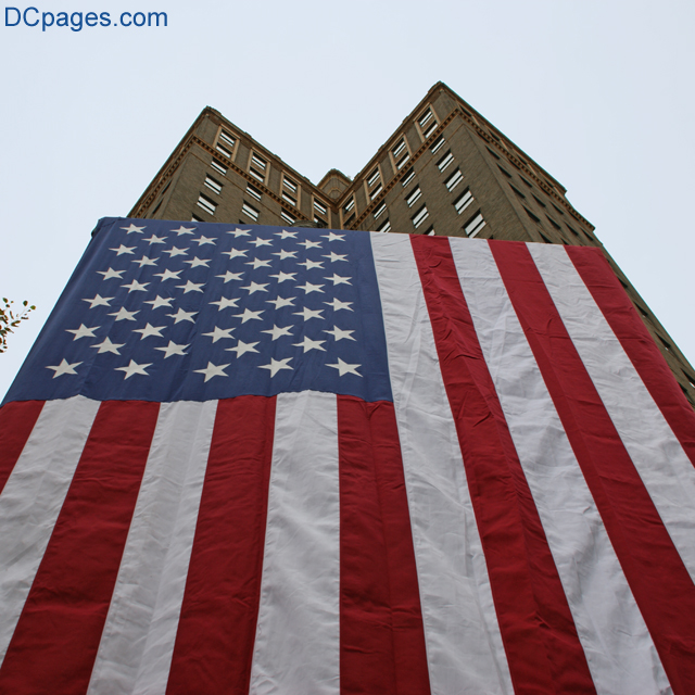 American flag stands tall next to the Suntrust Bank building.