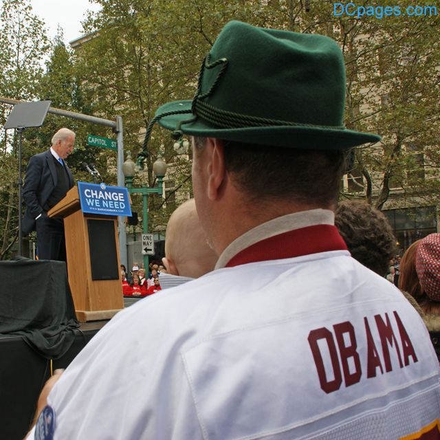 Father and son listen to Senator Joe Biden