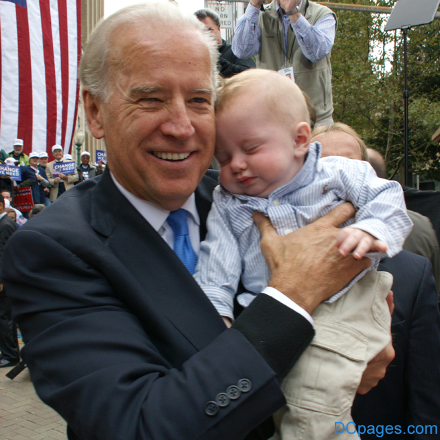 Baby Luke and Joe bump heads.