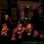 Lighted christmas snow rabbit, Santa Claus, Snow men, minature Christmas trees, snow flakes, and green lit garland can be seen at this display.