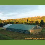 Cold frame with shade cover in the shadow of a cloud.