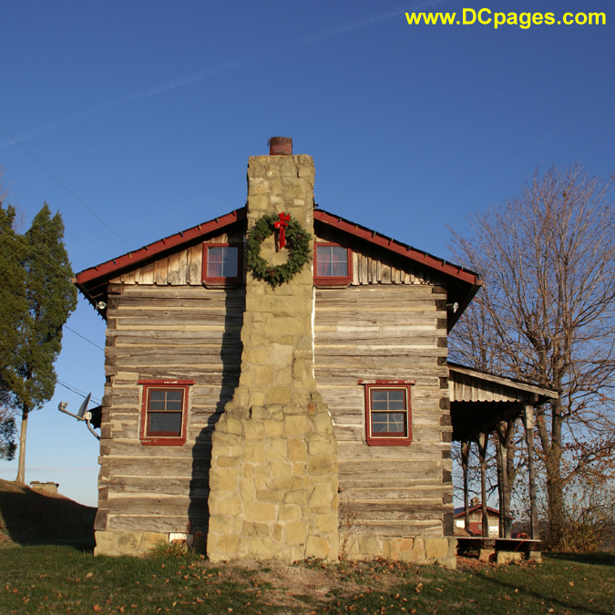 Christmas Wreath on cabin chimney.