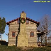 Christmas Wreath on cabin chimney.