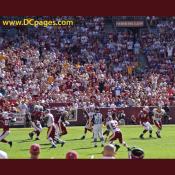 Chris Wilson (95) pressures Kurt Warner (13)