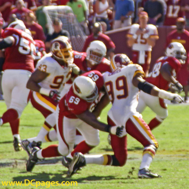 69-Offensive Tackle Mike Gandy grabs Andre Carter's jersey.