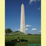 A safety spotter watches engineers on top of Washington Monument