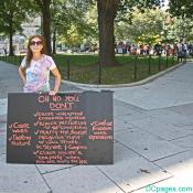 Female holding a large Occupy DC protest sign