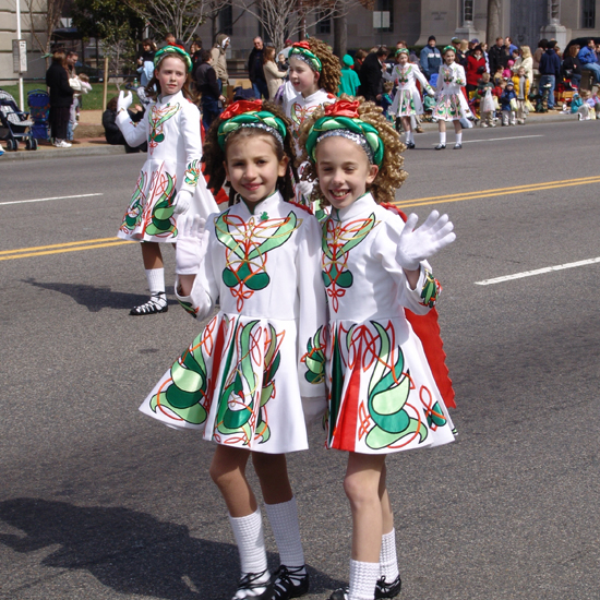 St Patricks day girls wave to the crowd.
