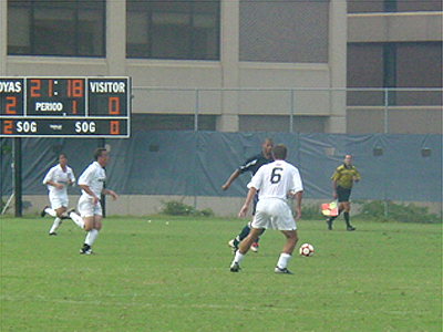 Dan Pydo, a Sophomore defender for the HOyas, tries to stop a Howard forward from scoring.