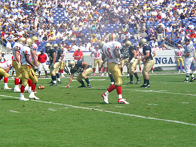 The players wait patiently for the referee's call on the last play.