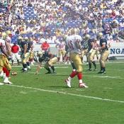 The players wait patiently for the referee's call on the last play.