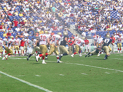 The players hussle to the ball after kick-off.