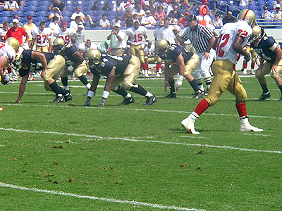 The Midshipmen defensive line get ready to stop VMI from scoring.