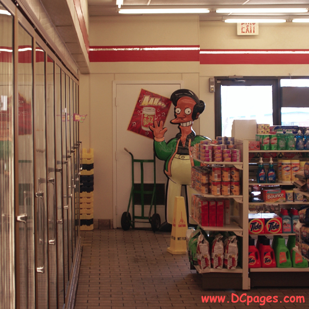Indian-American owner, Apu Nahasapeemapetilon Jr. takes some time to wave before stocking his shelves.