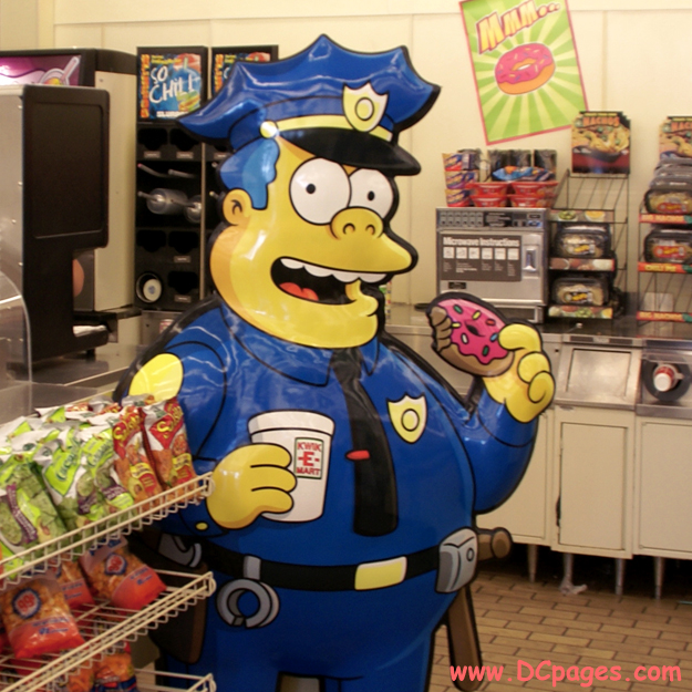 Chief Wiggum enjoys a tasty doughnut at the Bladensburg KWIK-E-MART.