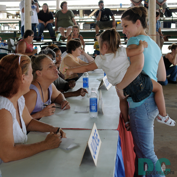 This little baby girl reaches out to a baby contest judge.