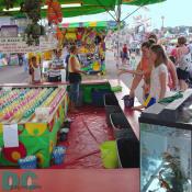 These youngsters are trying to win by throwing a ping-pong ball in a red, yellow, or green cup.
