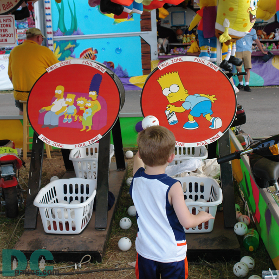 This boy tries to Hit Bart Simpson's butt with a wiffle ball. If your lucky the ball and the ball has the right top spin it will fall into the basket and you will win a prize.