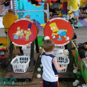 This boy tries to Hit Bart Simpson's butt with a wiffle ball. If your lucky the ball and the ball has the right top spin it will fall into the basket and you will win a prize.