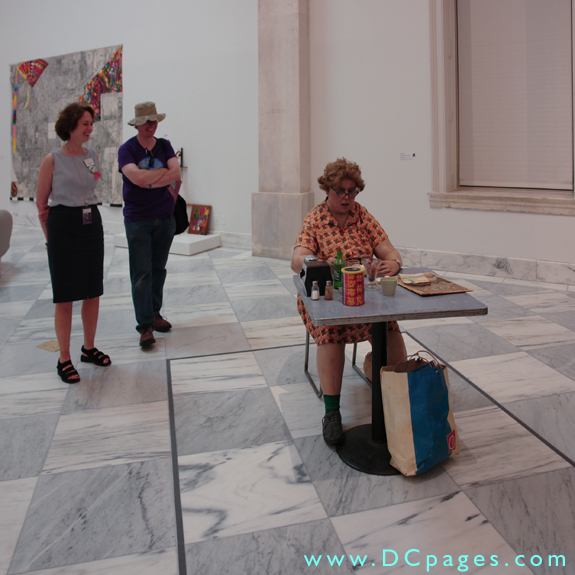 Third Floor - Contemporary Art - A very clever real life scupture of a woman sitting at a table.