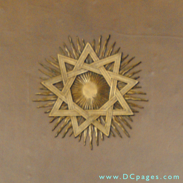 Bronze nine pointed star. Upon close examination there are three interlaced triangles. 