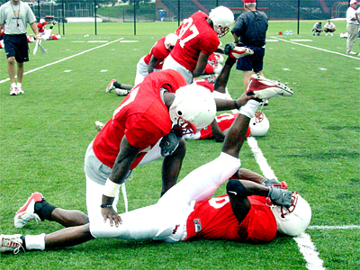 Players assist each other in their stretching.