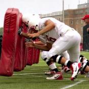 The offensive line takes turns with the tackling sleds.