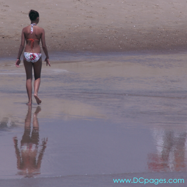 Ocean City - This young woman walks down the Ocean City coastline.