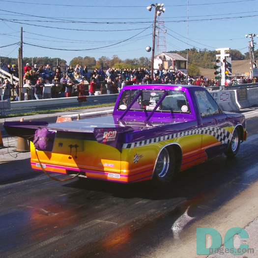 Another look at that winners flag 1991 Chevy S-10 top-fuel Pickup. The parrachute appers to be off center, but is actually hanging from the giant spoiler.