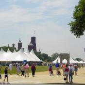 The Timbuktu Stage, where patrons have the opportunity to experience Malian music and dance.  The Smithsonian Castle is seen in the background and a Malian adobe gate welcomes visitors to experience the culture of Mali.