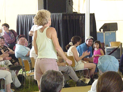 Inspired by the fiddling, this woman jumper up and started dancing