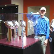 DCPages Ed Palmedo and Rachel Greenberg standing next to Redskin greatness.