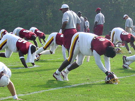 LB Lavar Arrington stretching to warm up.