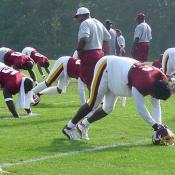 LB Lavar Arrington stretching to warm up.