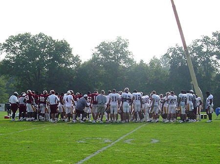 One big team huddle before breaking the offense and defense apart.